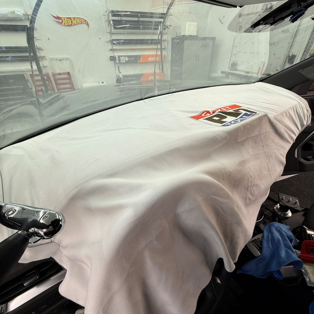 Professional use of Protective Dash Towel on vehicle dash during tinting, safeguarding surfaces from damage.